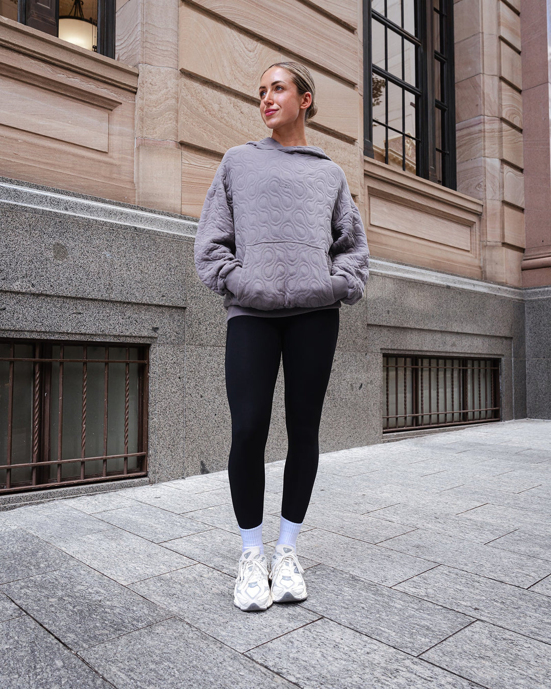 Woman wearing MVP Quilted Oversized Hoodie - Storm Front-Geometric | Model:Paris | Size:XS