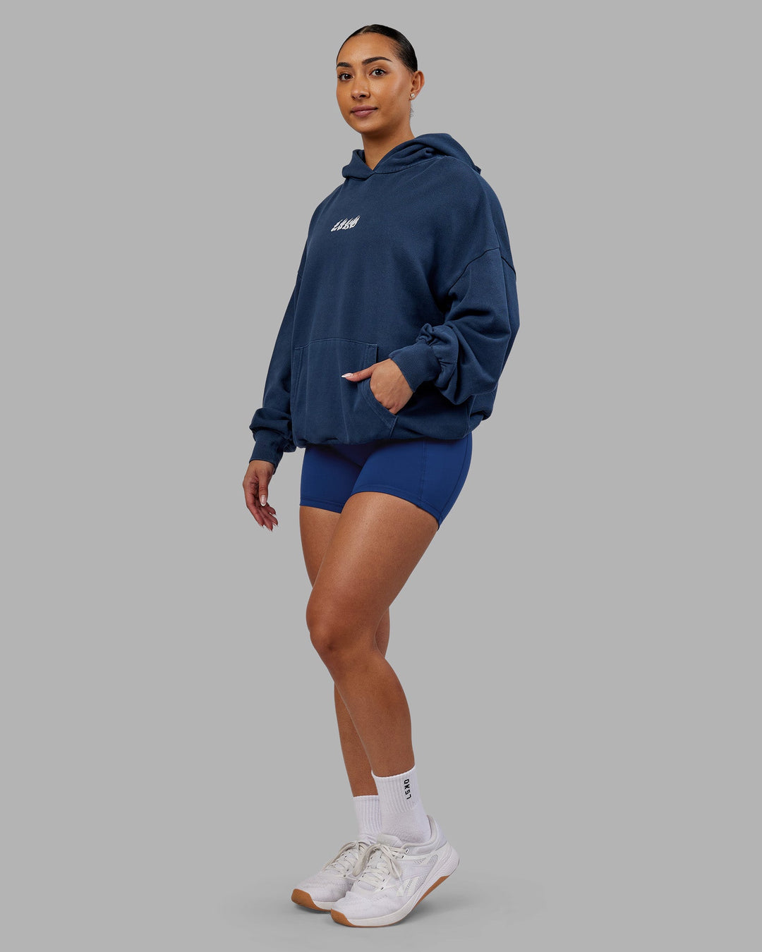 Woman wearing NY25 Washed Oversized Hoodie - Future Navy-Ultra Orange | Model:Ayla | Size:XS