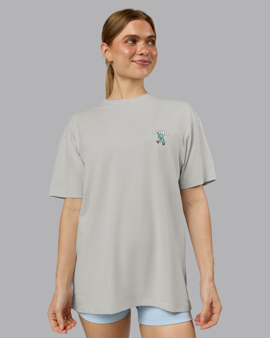 Woman wearing Perspective FLXCotton Oversized Tee - Digital Mist-White | Model:Emilie | Size:XS