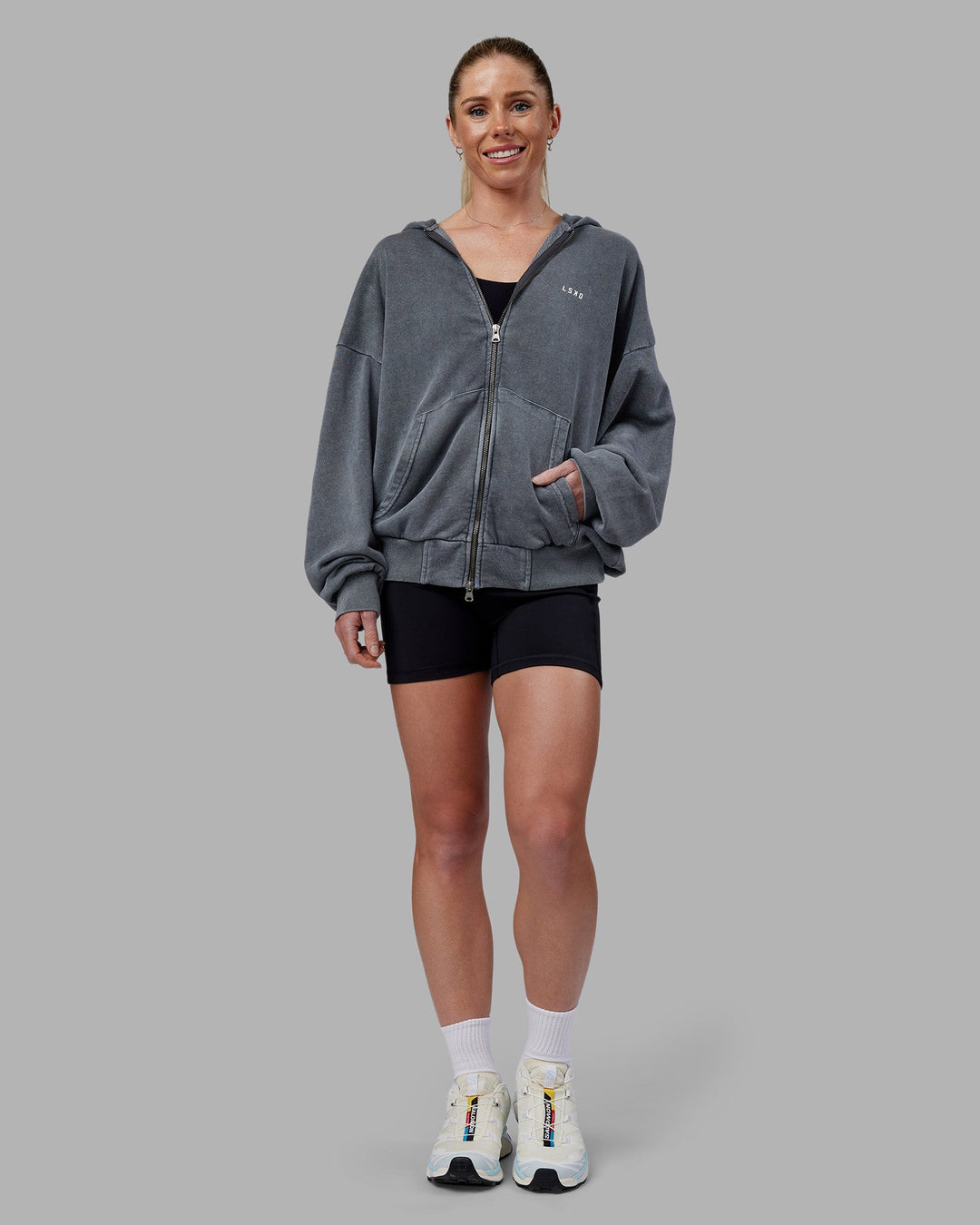 Woman wearing Relentless Washed Zip Through Oversized Hoodie - Dark Storm-White | Model:Kayti | Size:XS