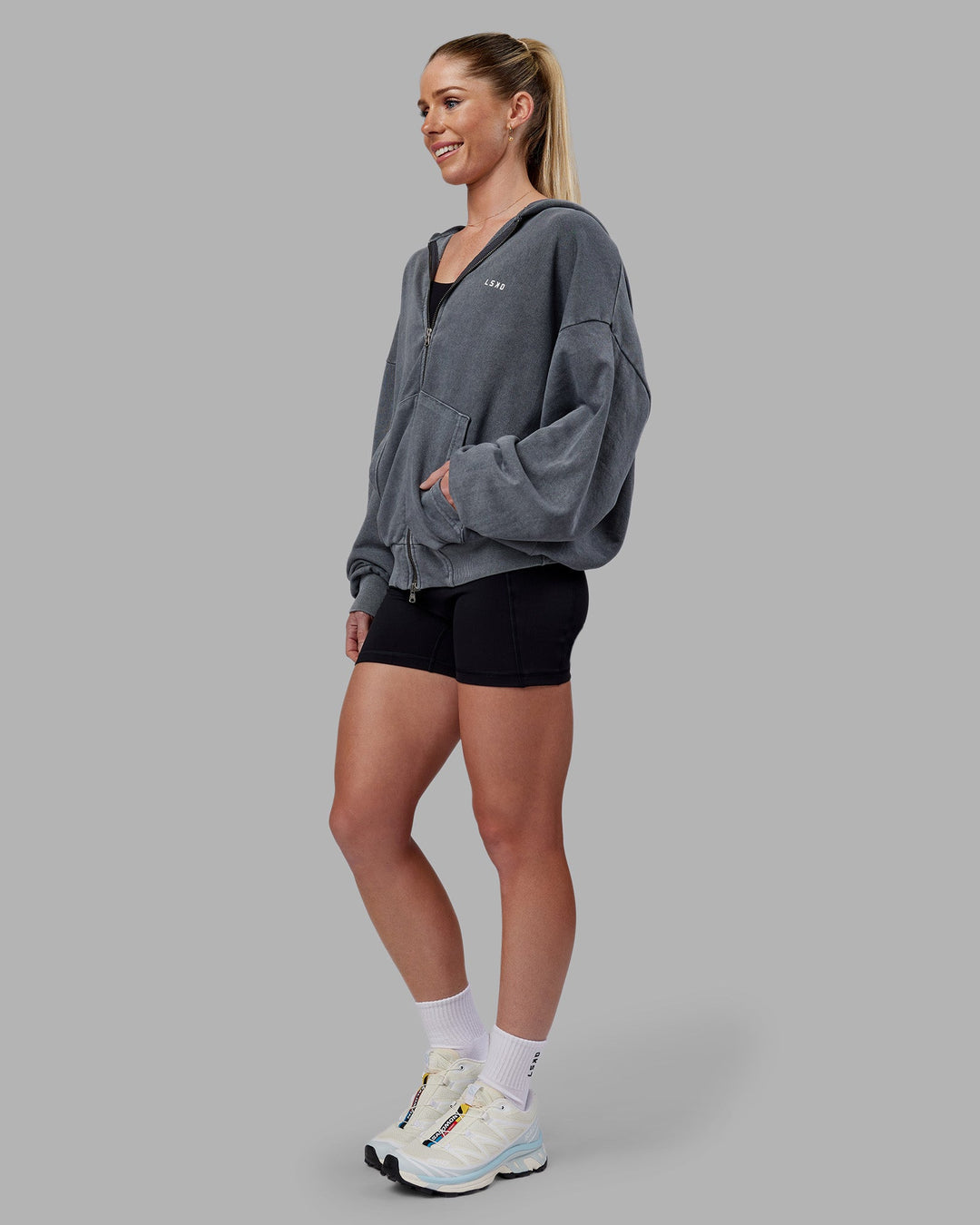 Woman wearing Relentless Washed Zip Through Oversized Hoodie - Dark Storm-White | Model:Kayti | Size:XS