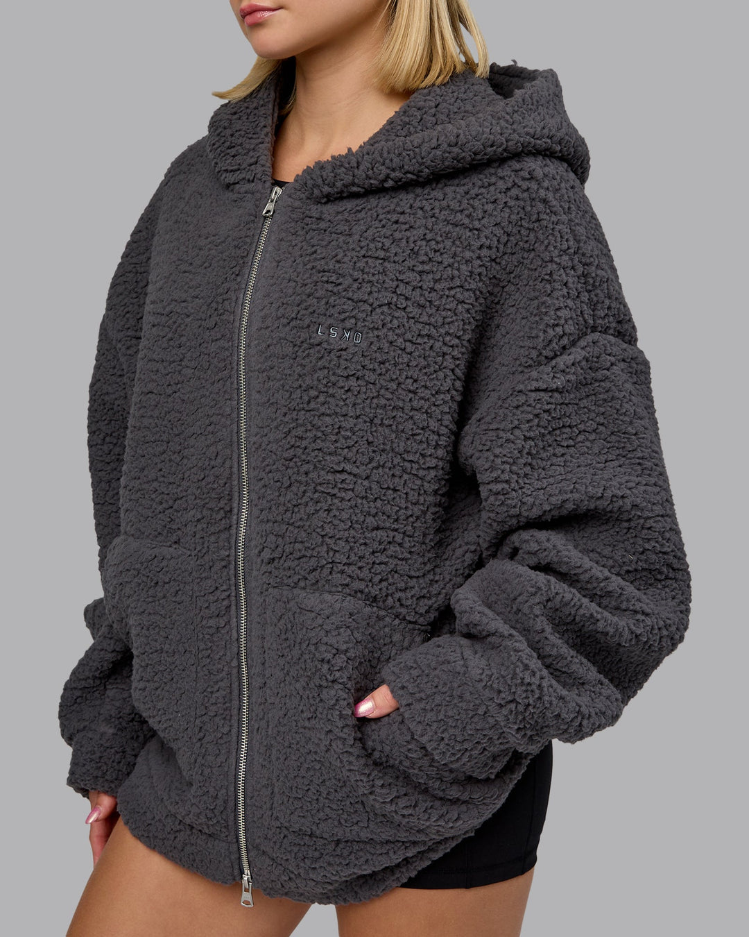 Woman wearing Sherpa Oversized Jacket - Dark Storm | Model:Halle | Size:XS