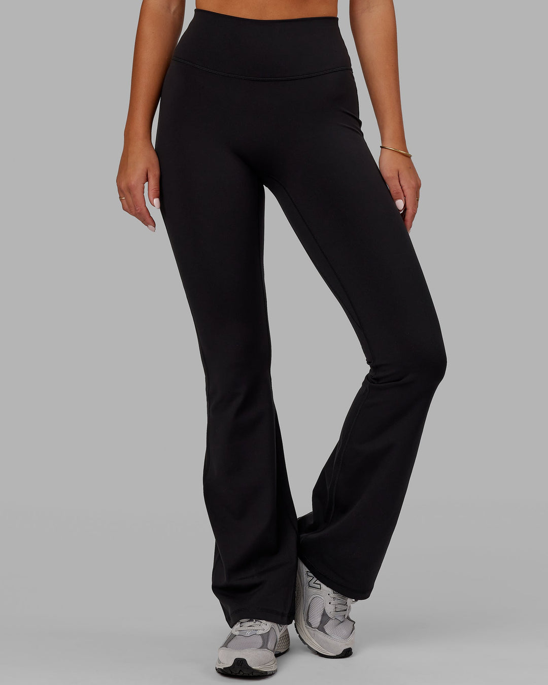 Woman wearing Fusion Ultra High-Rise Flared Legging - Black | Model:Milly | Size:S