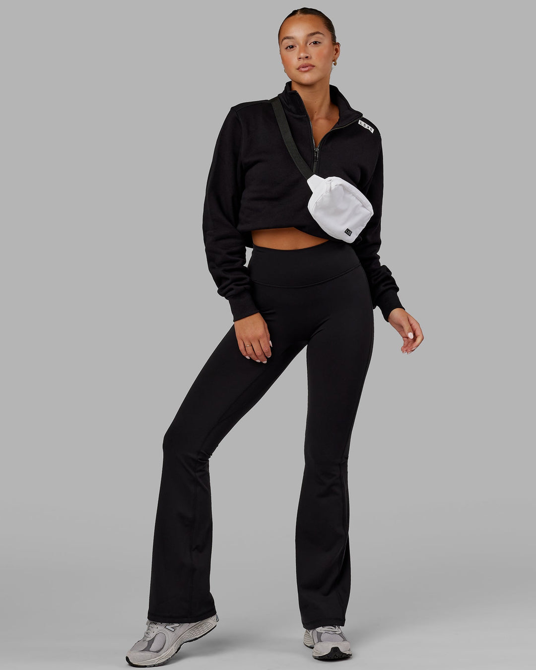 Woman wearing Fusion Ultra High-Rise Flared Legging - Black | Model:Milly | Size:S