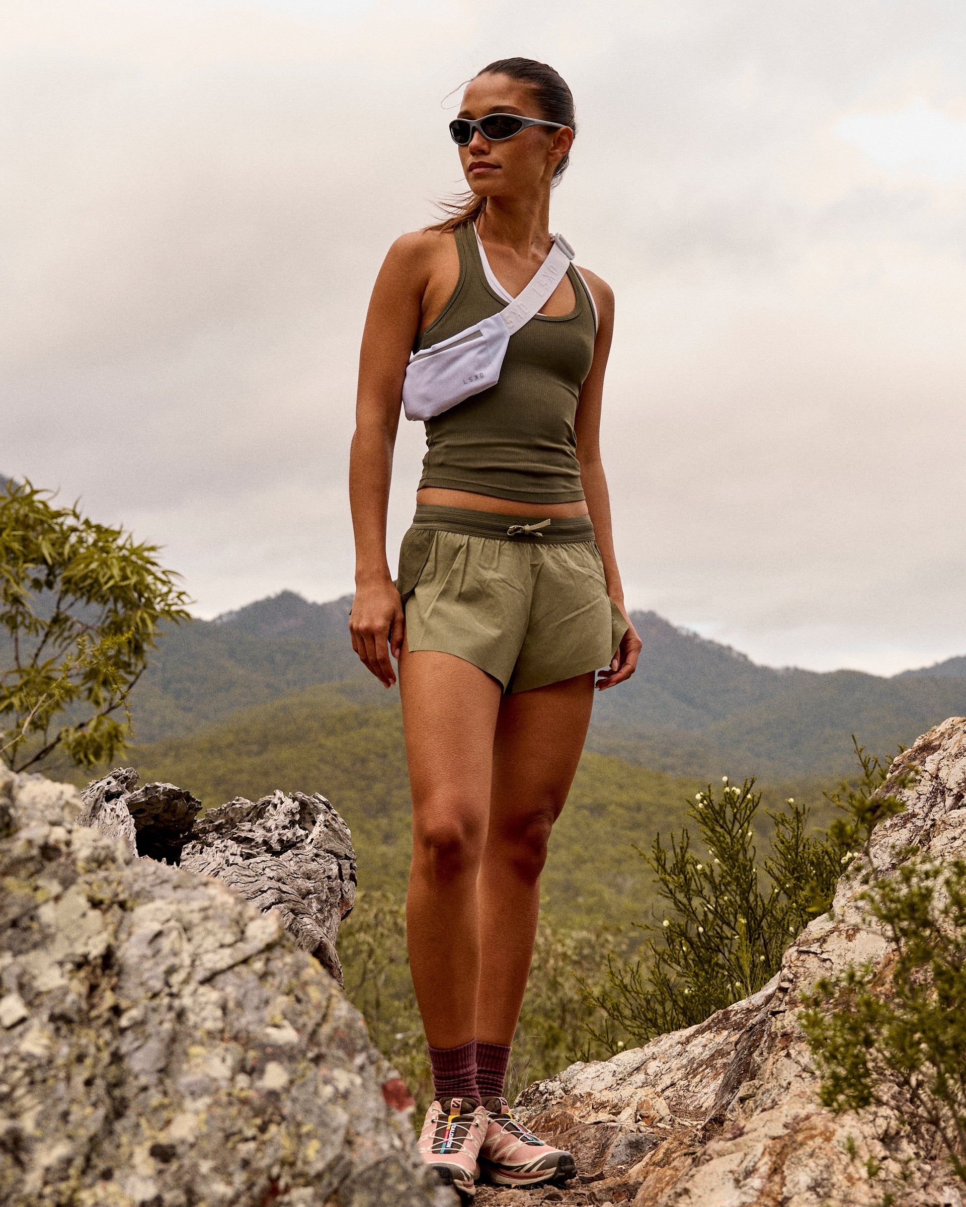 Woman wearing Accelerate 3" Mid-Rise Running Short - Pure Olive-Fog