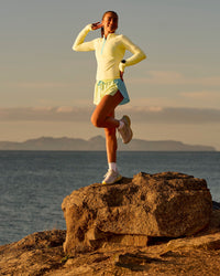 Woman wearing GG AeroFLX+ Long Sleeve Half Zip - Lemon-Baltic Sea | Model:Grace | Size:XS