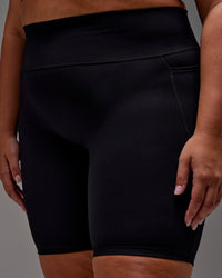 Woman wearing Fusion Ultra High-Rise 9" Short Pockets - Black | Model:Jordie | Size:2XL