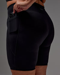 Woman wearing Fusion Ultra High-Rise 9" Short Pockets - Black | Model:Jordie | Size:2XL