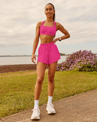 Woman wearing Accelerate 3" High-Rise Running Short - Ultra Pink | Model:Zara | Size:2XS