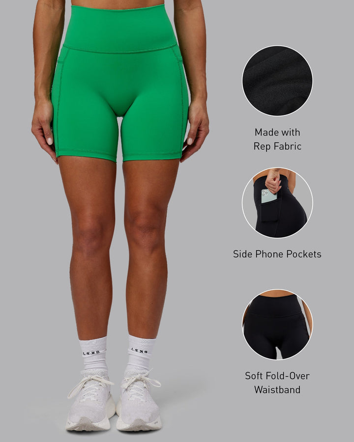 Woman wearing Fusion Mid-Length Shorts - Impact Green
