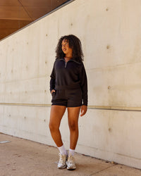 Woman wearing Elevate SoftTouch 4" Shorts - Black-Black