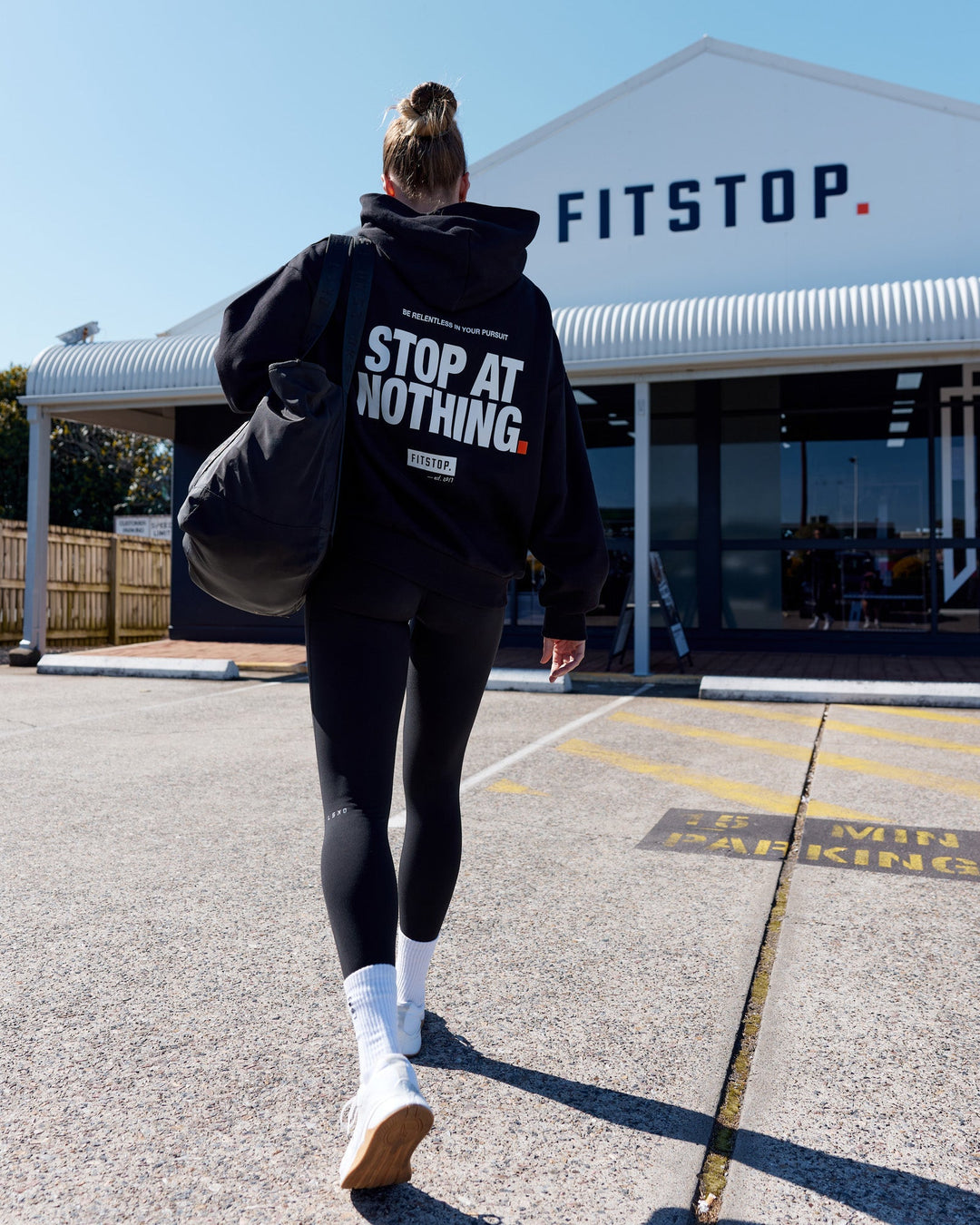 Woman wearing Unisex Fitstop Stop at Nothing Hoodie Oversize - Black