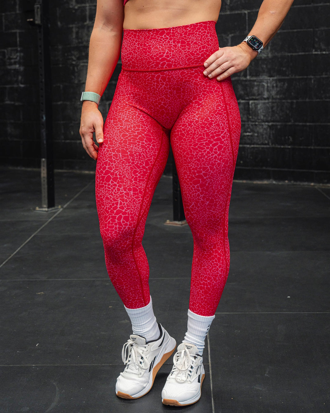 Woman wearing Fusion Ultra High-Rise 7/8 Legging Pockets - Red Vitality Print | Model:Merita | Size:S