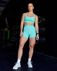 Woman wearing Fusion Ultra High-Rise 6" Short Pockets - Aquatic Awe | Model:Suz | Size:S