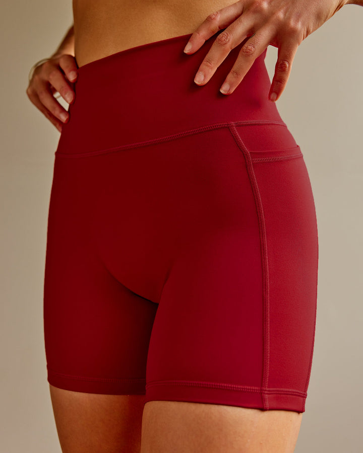 Woman wearing Fusion Mid Short Tights with Pockets - Cherry Red
