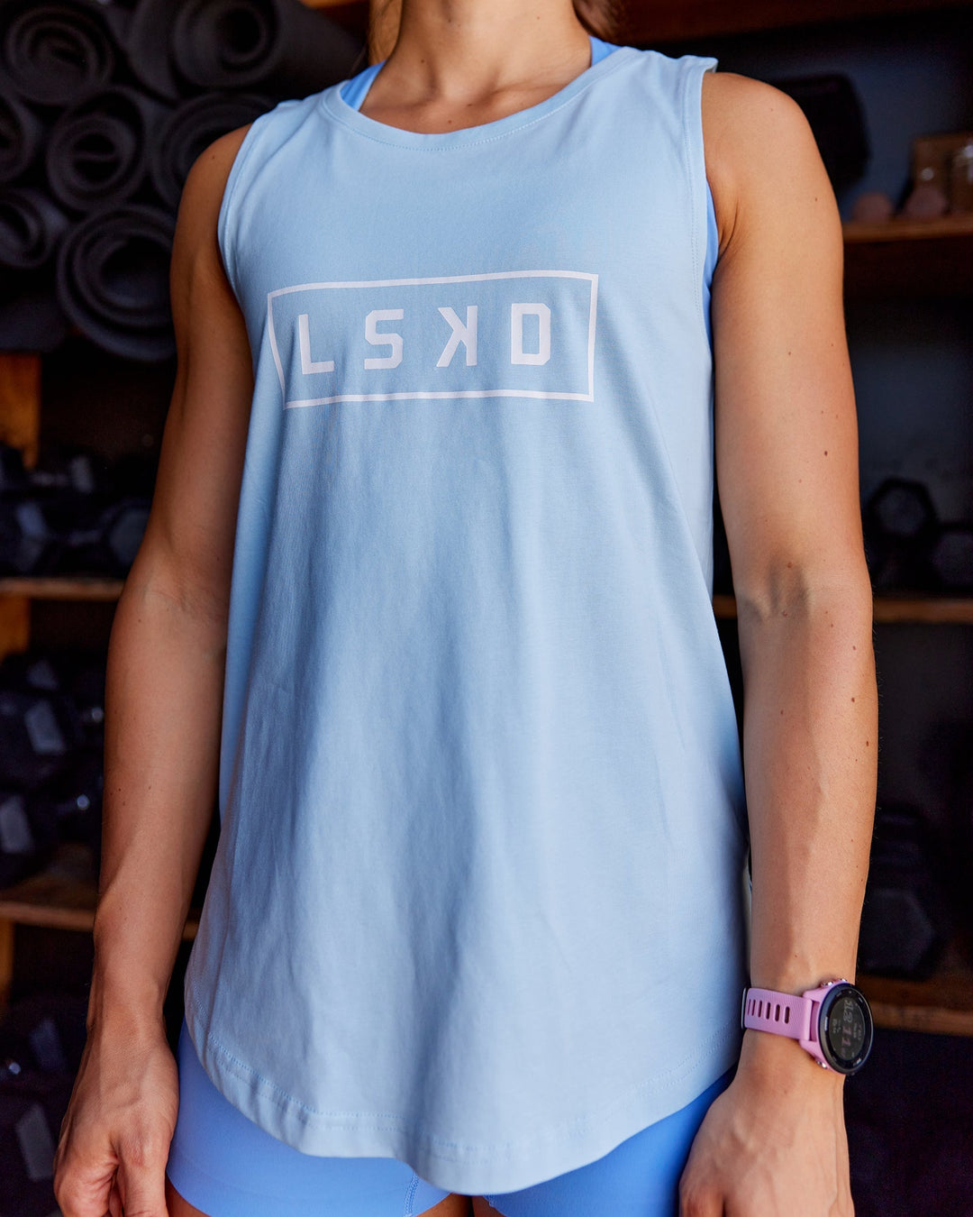 Woman wearing Luna FLXCotton Longline Tank - Glacial Blue-White