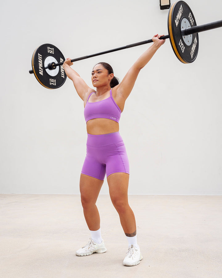 Woman wearing Momentum Sports Bra - Purple Fizz
