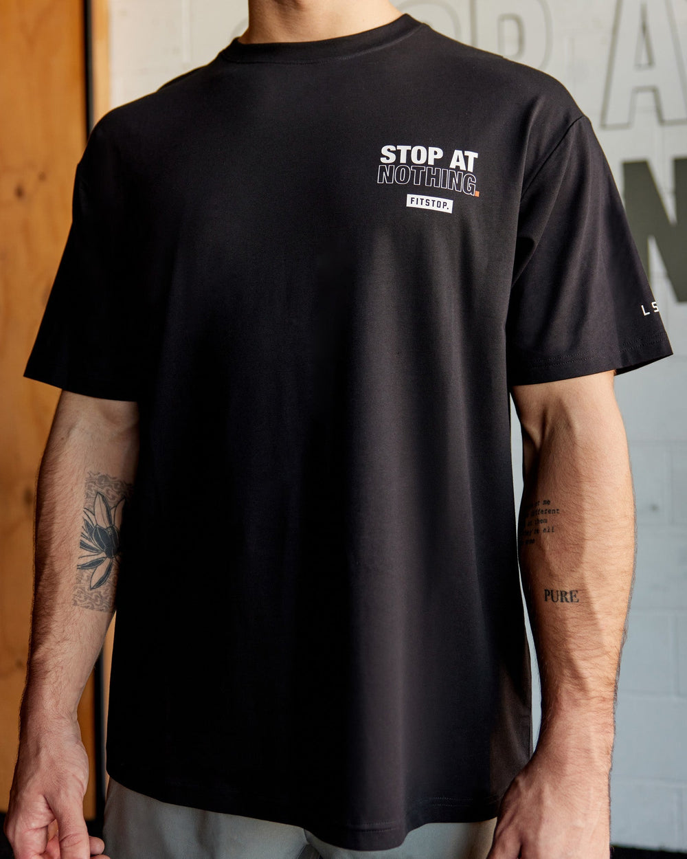 Man wearing Unisex Fitstop Stop at Nothing Tee Oversize - Black-White