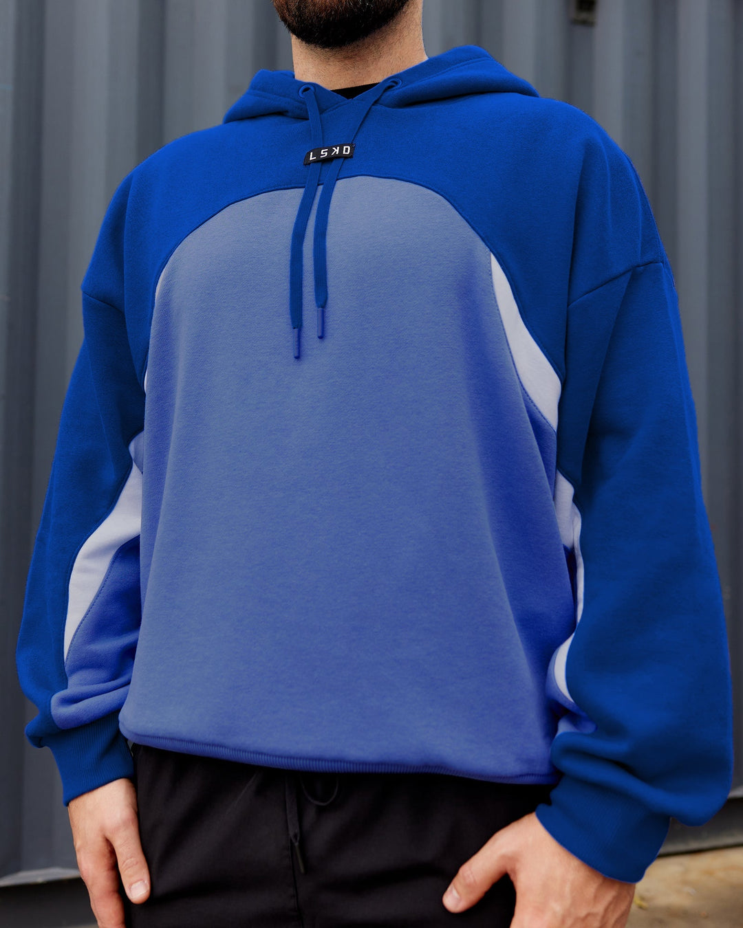 Man wearing Unisex Y2K Concept Panel Hoodie - Power Cobalt-White