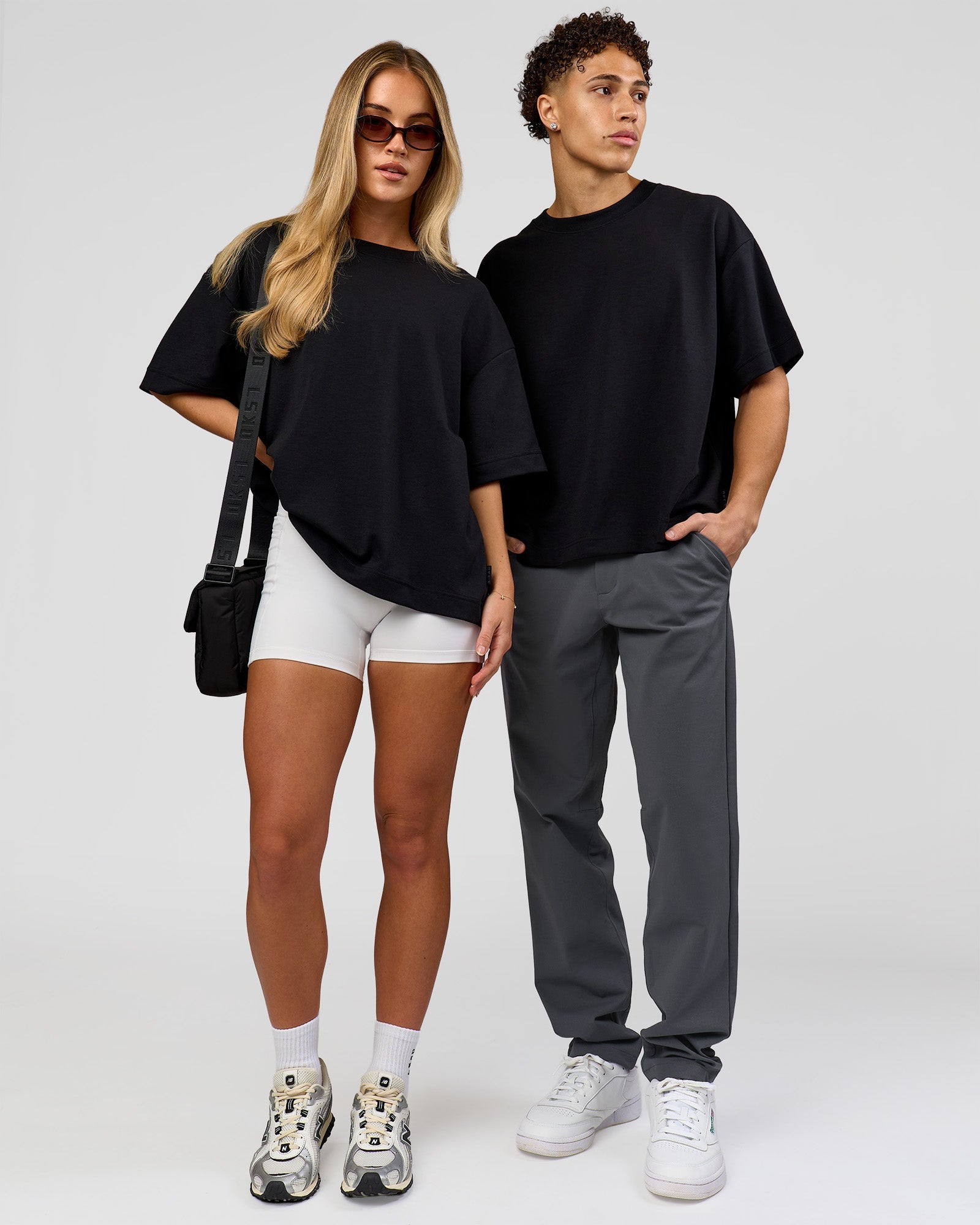 Duo wearing AfterDark ZeroCrease Boxy Tee in Black | Model:Issy | Size:XS | Model:Leandro | Size:M