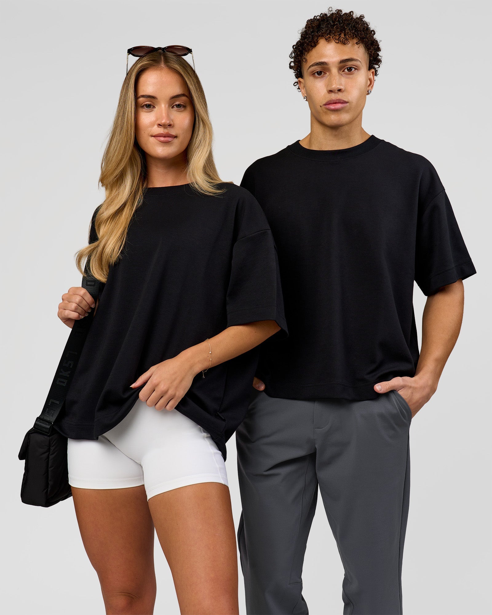 Duo wearing AfterDark ZeroCrease Boxy Tee in Black | Model:Issy | Size:XS | Model:Leandro | Size:M