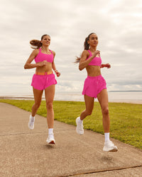 Woman wearing Accelerate 3" High-Rise Running Short - Ultra Pink | Model: Duo | Size:Both