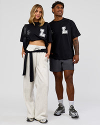 Duo wearing Hype Heavyweight Unisex Oversized Tee - Black-White | Model:Leilani | Size:XS | Model:Xavier | Size:L