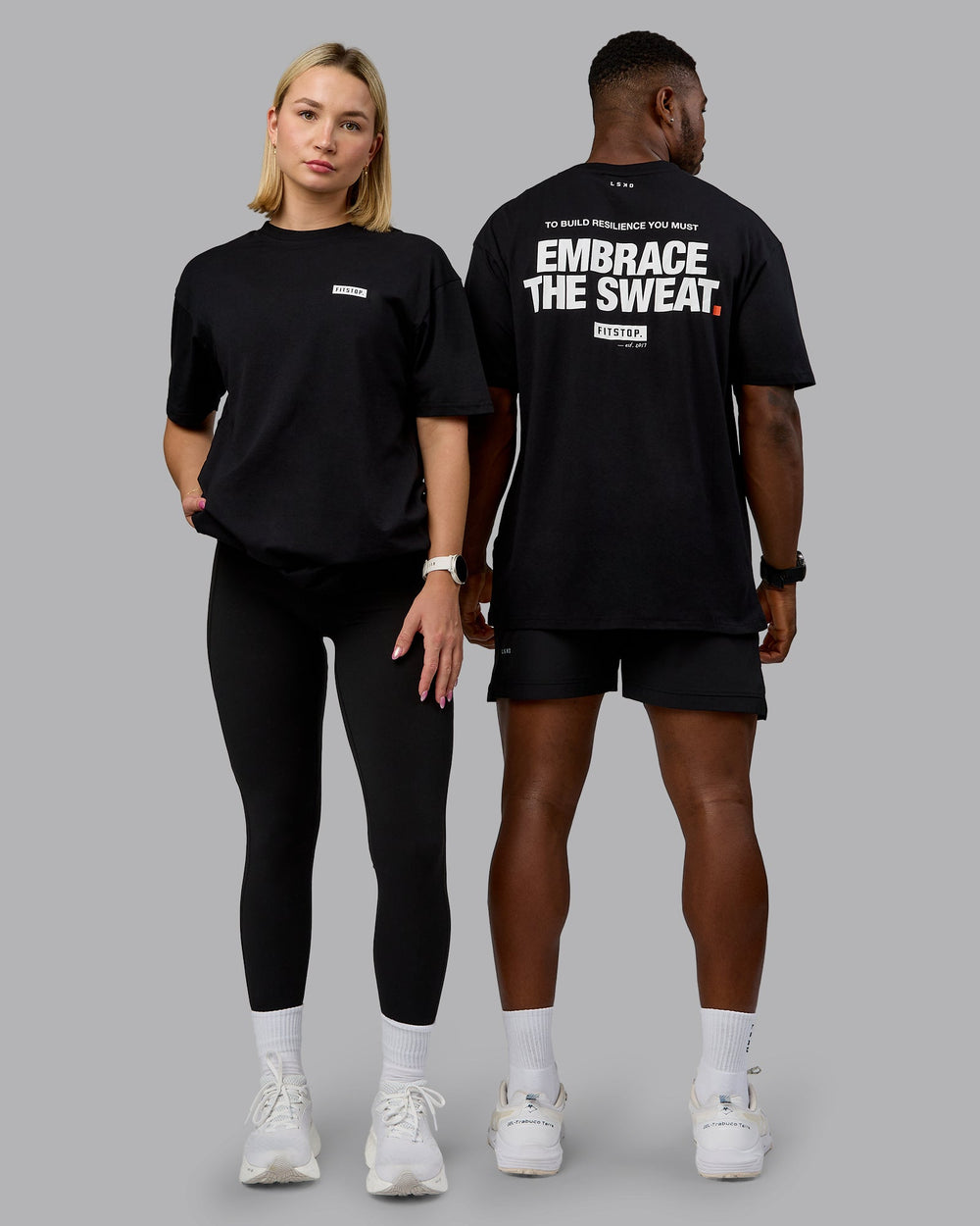 Duo wearing Fitstop Embrace the Sweat FLXCotton Oversized Tee in Black-White | Size:Duo