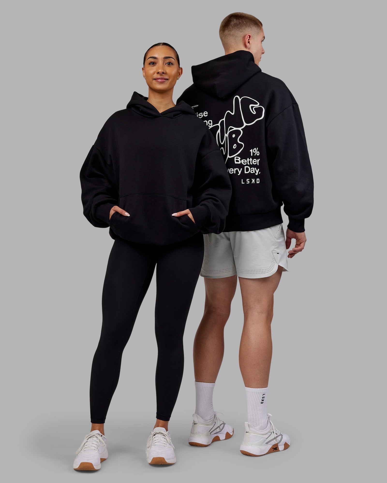 Duo wearing Rise & Lift Hoodie Oversized - Black-White | Model:Both | Size:Duo
