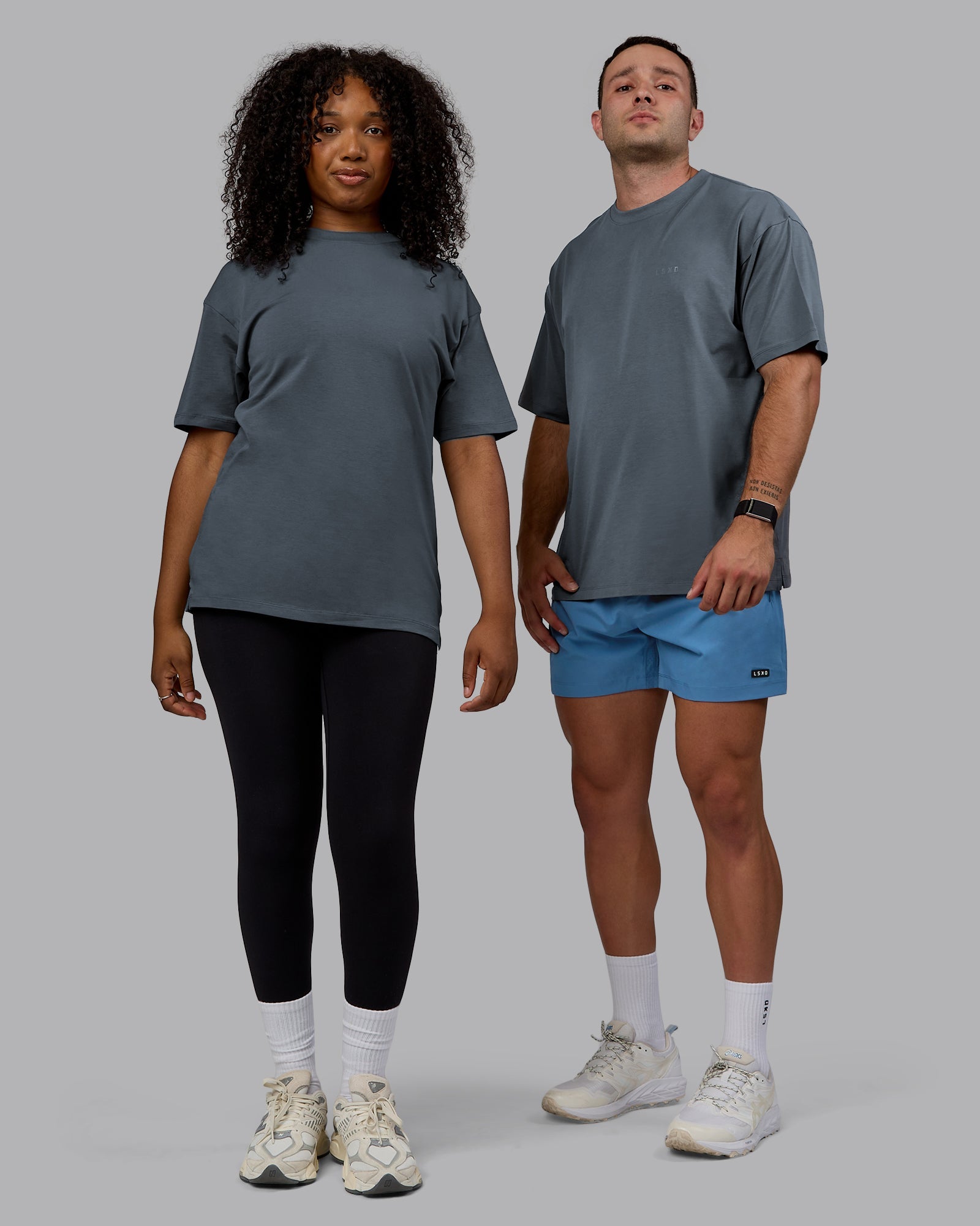 Duo wearing Unisex Deluxe PimaFLX Tee Oversize - Turbulence