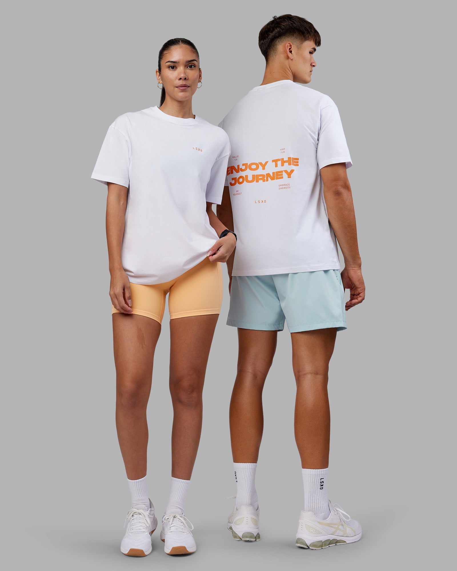 Duo wearing Enjoy the Journey Value Series FLXCotton Tee Oversize - White-Vibrant Orange | Model:Both | Size:Duo
