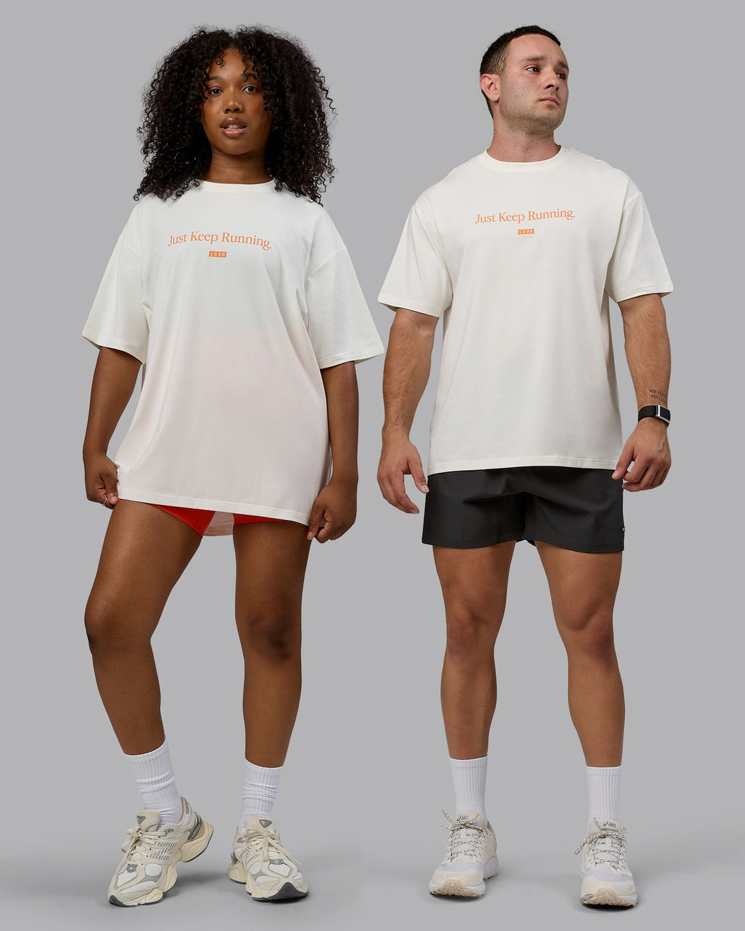 Duo wearing Unisex Just Keep Running FLXCotton Tee Oversize - Off White-Vibrant Orange