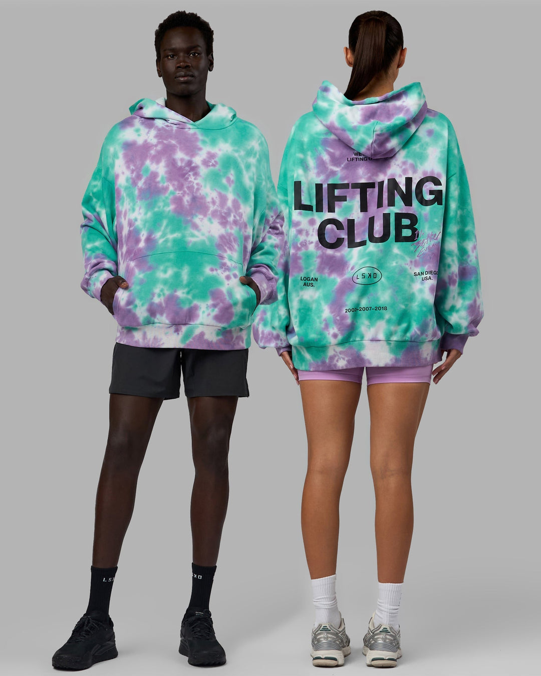 Duo wearing Unisex Lifting Club Hoodie Oversize - Cockatoo-Tie Dye