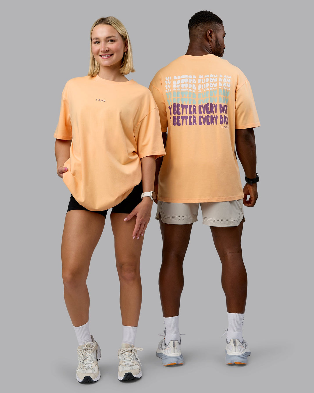 Duo wearing On Repeat FLXCotton Oversized Tee - Peach Fuzz-White | Model:Both | Size:Duo