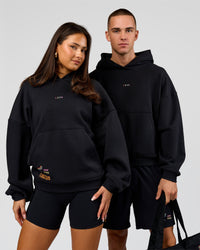 Duo wearing Pride Sticker Boxy Hoodie - Black | Model:Bianca | Size:XS | Model:Albert | Size:M