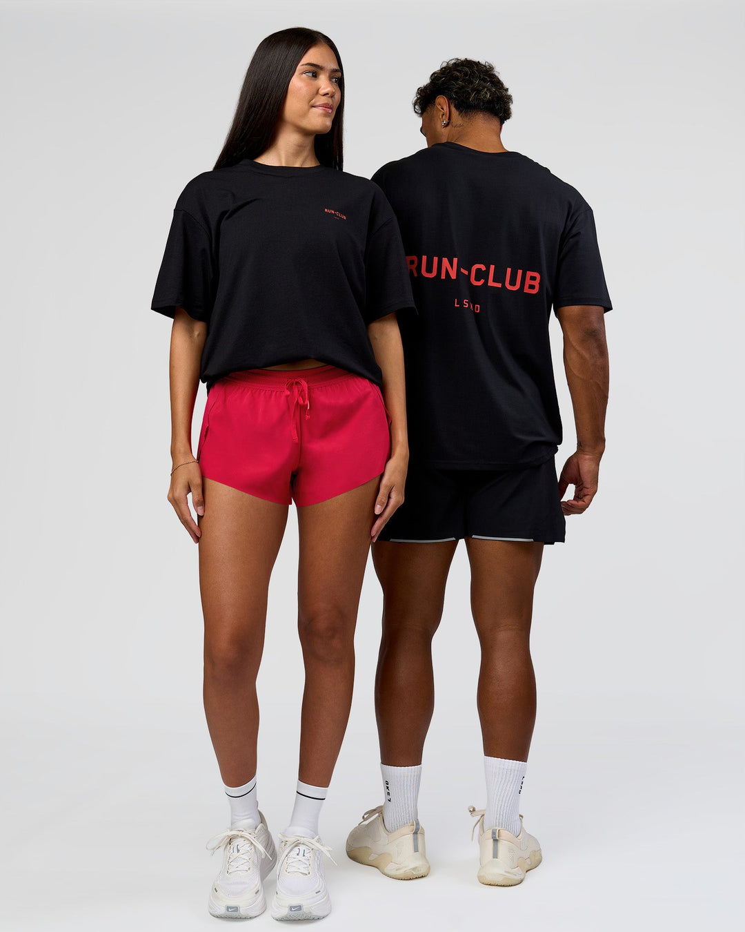 Duo wearing RUN CLUB FLXCotton Tee Oversize - Black-Scarlet | Model:Xav | Size:L | Model:Rhiley | Size:XS