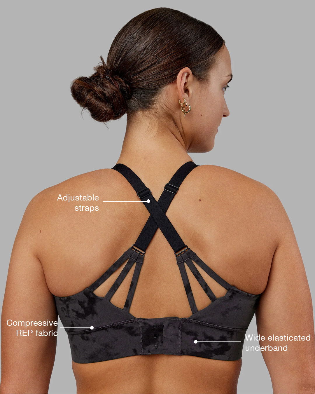 Woman wearing Accelerate Split Strap Sports Bra - Black Tie Dye | Model:Keisha | Size:S