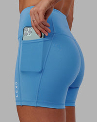 Woman wearing Flux Ultra High-Rise 4" Short Pockets - Azure Blue