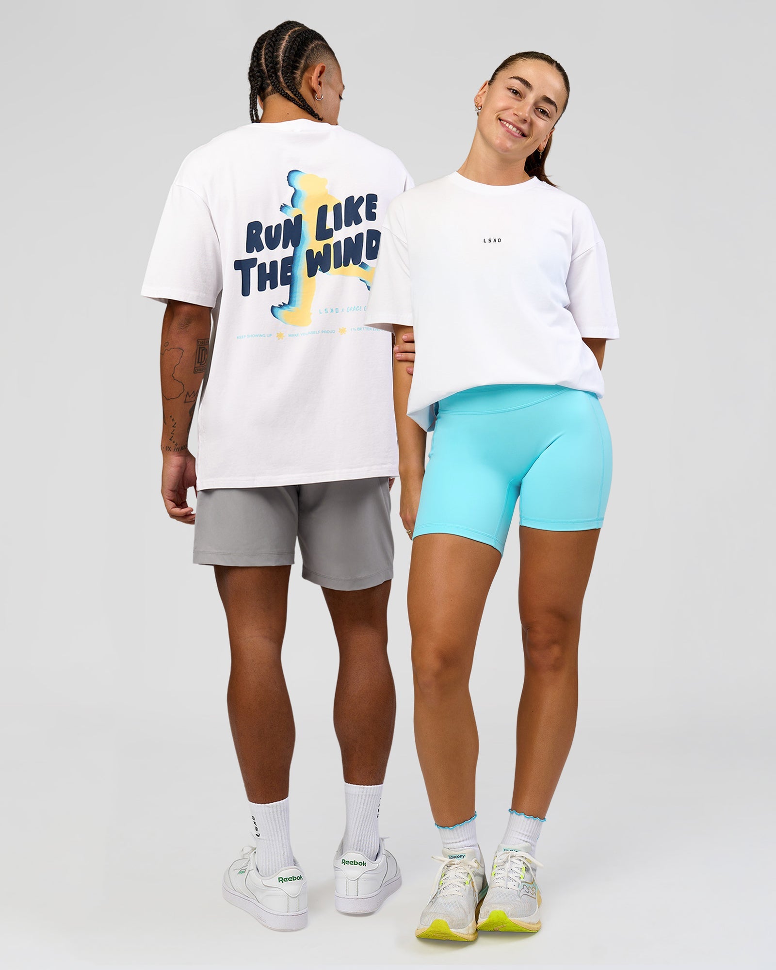 Duo wearing Woman wearing Woman wearing Run Like The Wind FLXCotton Oversized Tee - White-Future Navy | Model:Grace | Size:S | Model:Malebo | Size:M