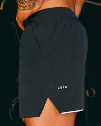 Man wearing Hybrid 5" Short - Black-Reflective | Model:Xav | Size:L