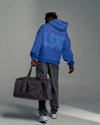 Man wearing Memory In Motion Ultra Heavyweight Washed Hoodie - Electric Indigo Washed | Model:Okello | Size:L