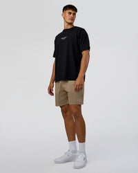 Man wearing 1% Better Every Day EST FLXCotton Oversized Tee - Black | Model:Jackson | Size:L