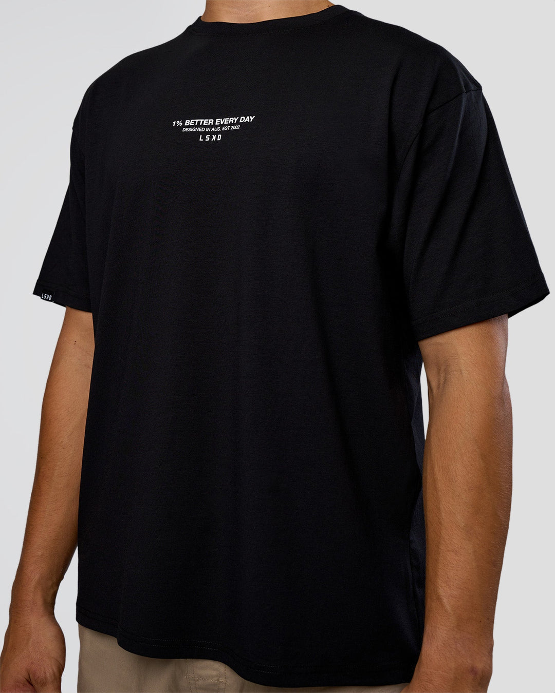 Man wearing 1% Better Every Day EST FLXCotton Oversized Tee - Black | Model:Jackson | Size:L