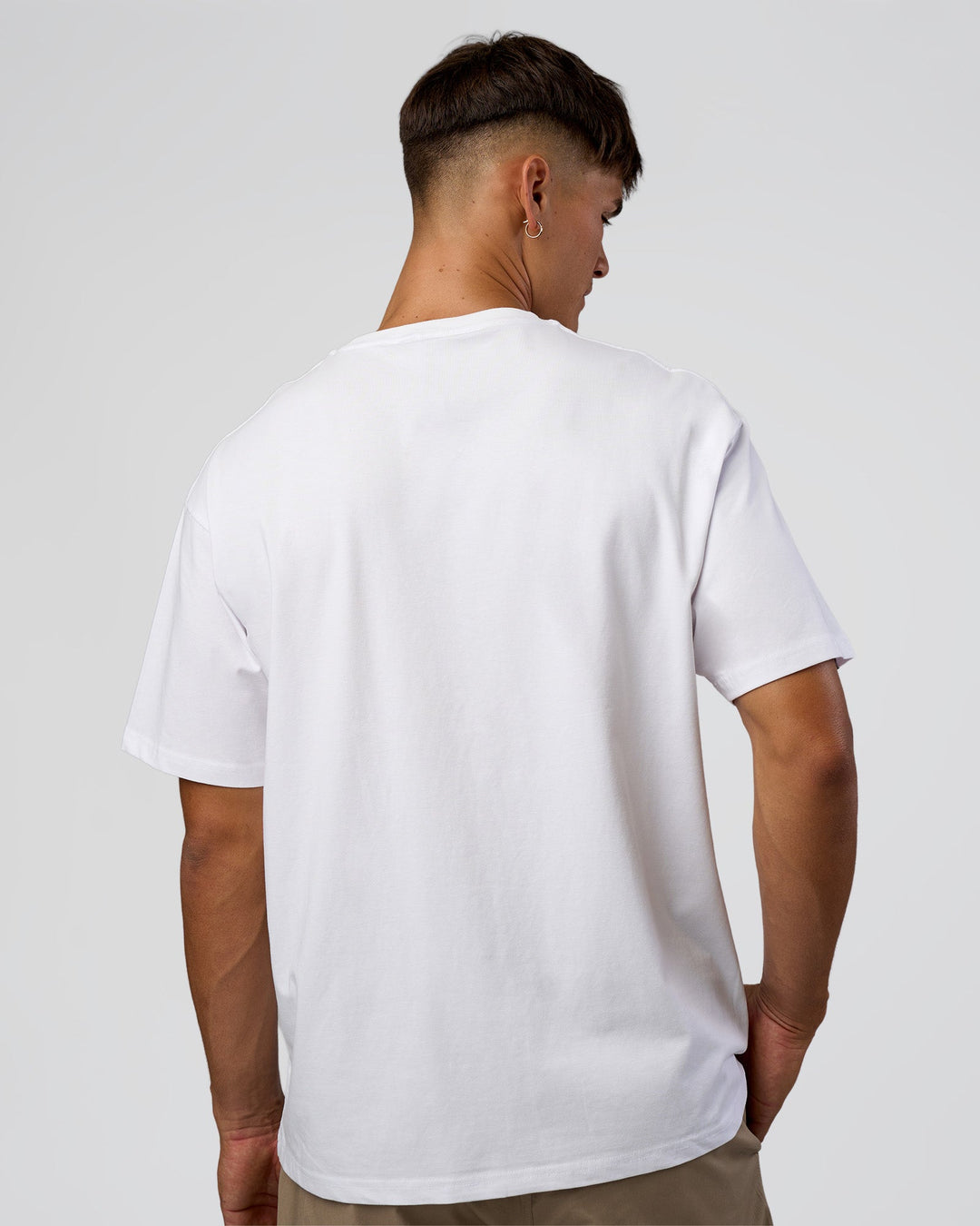 Man wearing 1% Better Every Day EST FLXCotton Oversized Tee - White | Model:Jackson | Size:L