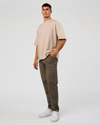 Man wearing AfterDark ZeroCrease Oversized Tee - Shale Beige | Model:Jackson | Size:L | Thumbnail Index: 2