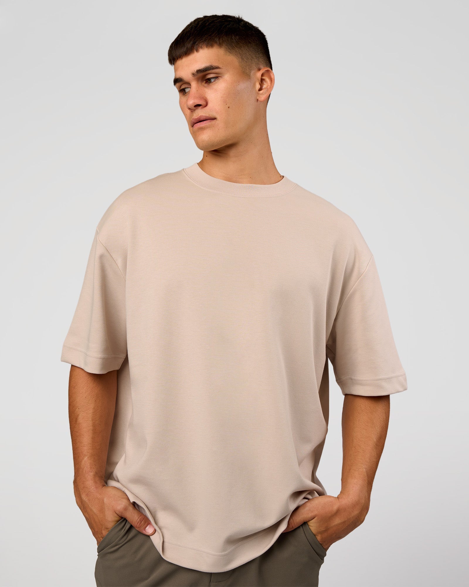 Man wearing AfterDark ZeroCrease Oversized Tee - Shale Beige | Model:Jackson | Size:L