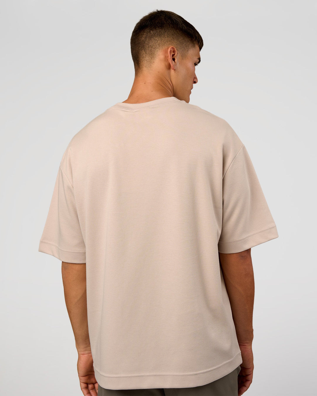 Man wearing AfterDark ZeroCrease Oversized Tee - Shale Beige | Model:Jackson | Size:L - view 6