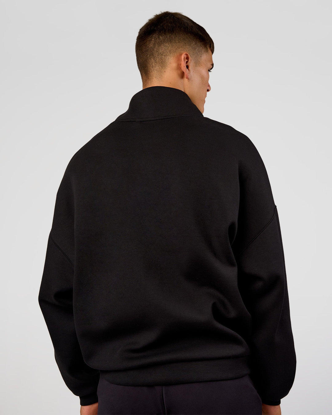 Man wearing AfterDark ZeroCrease Quarter Zip - Black | Model:Jackson | Size:L