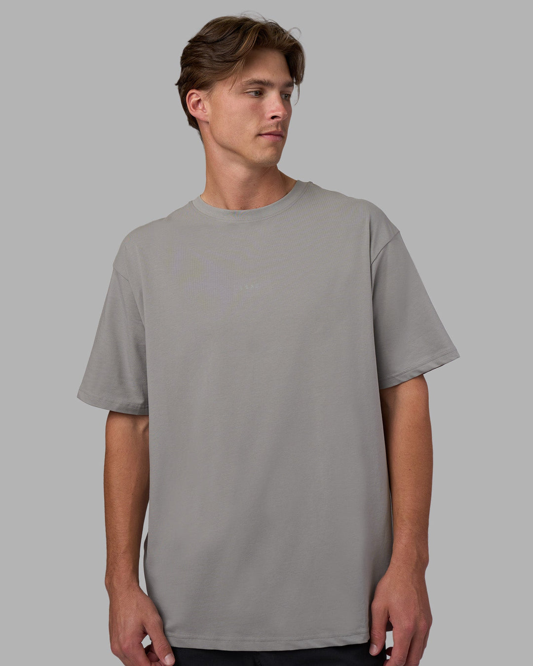 Man wearing Base FLXCotton Tee Oversized - Circular-Grey  Model:Brandon | Size:L