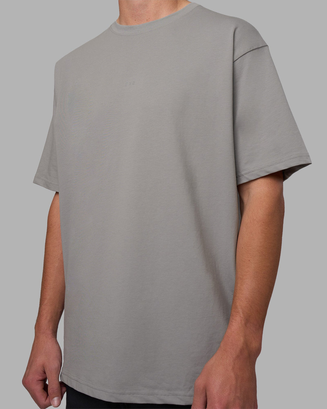 Man wearing Base FLXCotton Tee Oversized - Circular-Grey  Model:Brandon | Size:L